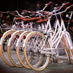 Four identical white bicycles showing no innovations since the 1970s